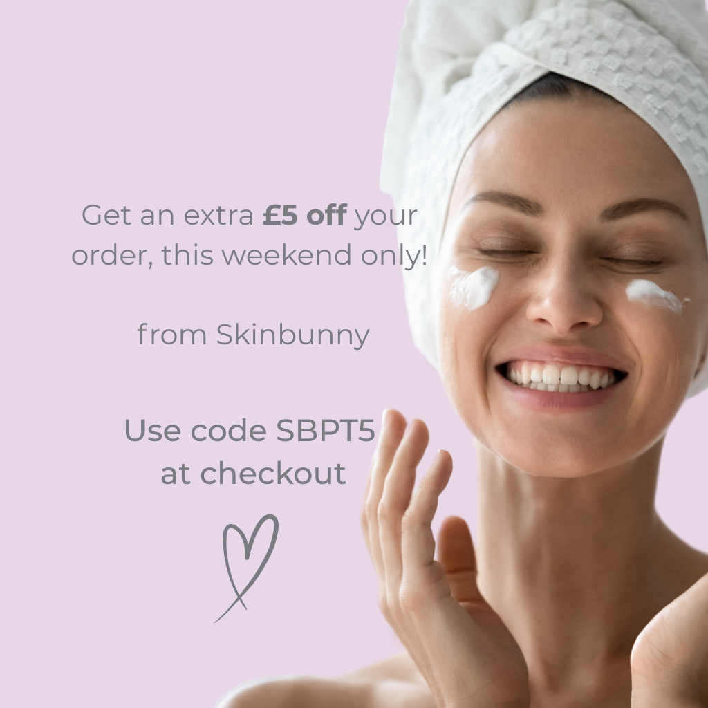 Woman applying cream to her face with a promotional message from Skinbunny on a pink background